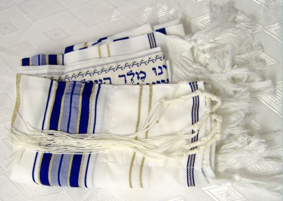 Before putting on a tallit, it is a customary tradition to kiss it and 